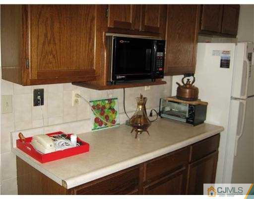 31 Purdue Road Old Bridge, NJ 08859 - Photo 4 of 6 a kitchen with a sink a microwave and cabinets