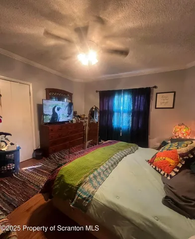 a bedroom with a bed and dresser with mirror