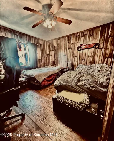 a bedroom with a bed window and dresser