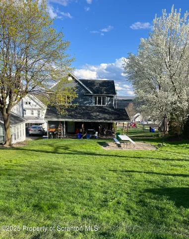a front view of a house with a yard table and chairs