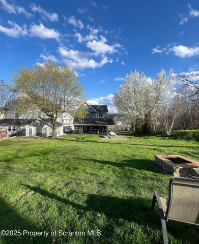 a view of a big yard with plants and a garden
