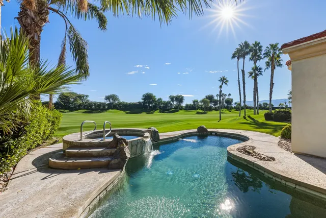 a view of a swimming pool and lounge chairs