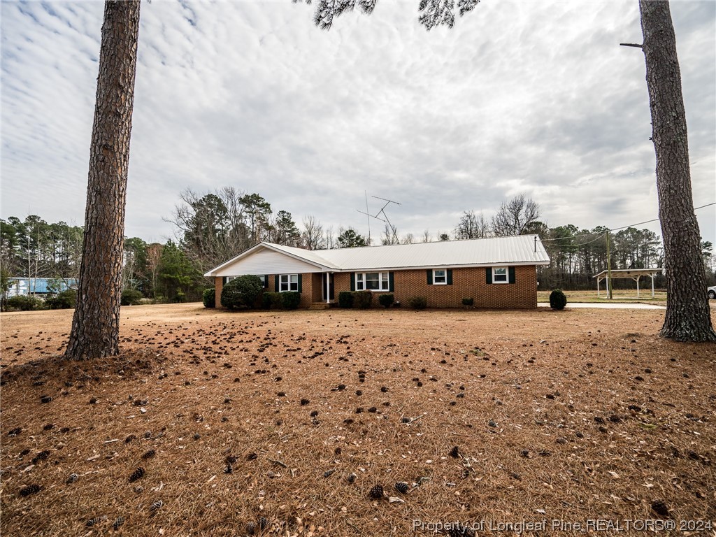 1982 Rowan Road, Unit R Lumberton, NC 28358 - Photo 1 of 43 a view of a large house with a big yard and large trees