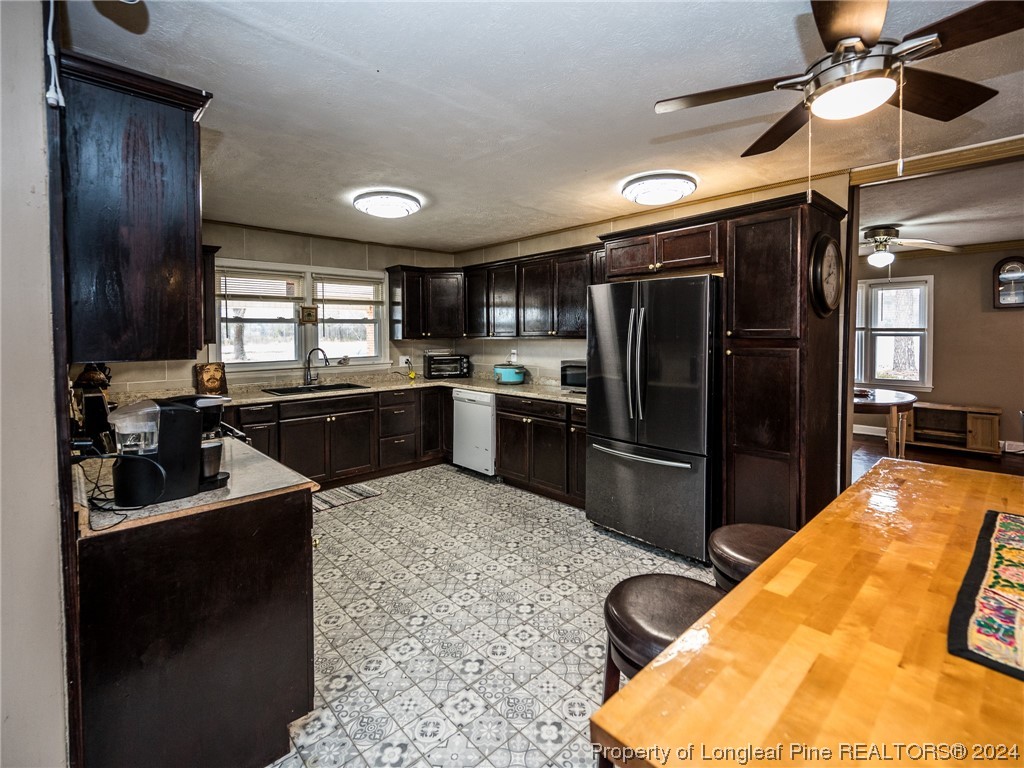1982 Rowan Road, Unit R Lumberton, NC 28358 - Photo 12 of 43 a kitchen with stainless steel appliances granite countertop a sink a stove and refrigerator