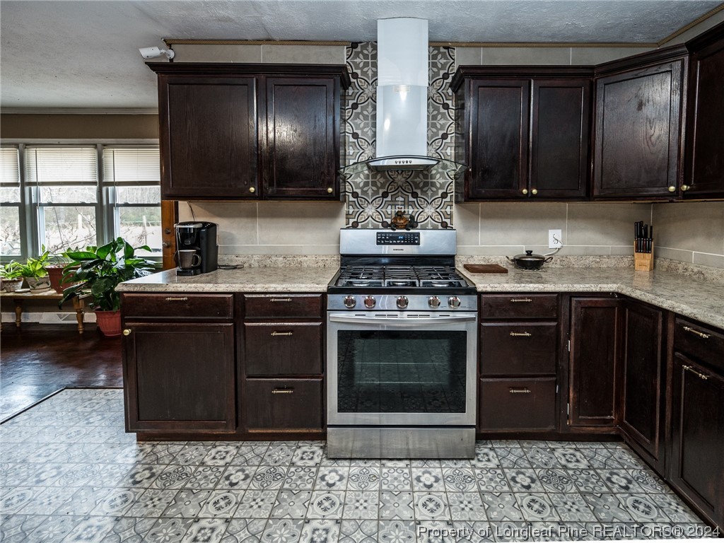 1982 Rowan Road, Unit R Lumberton, NC 28358 - Photo 13 of 43 a kitchen with stainless steel appliances granite countertop a stove a sink and a microwave