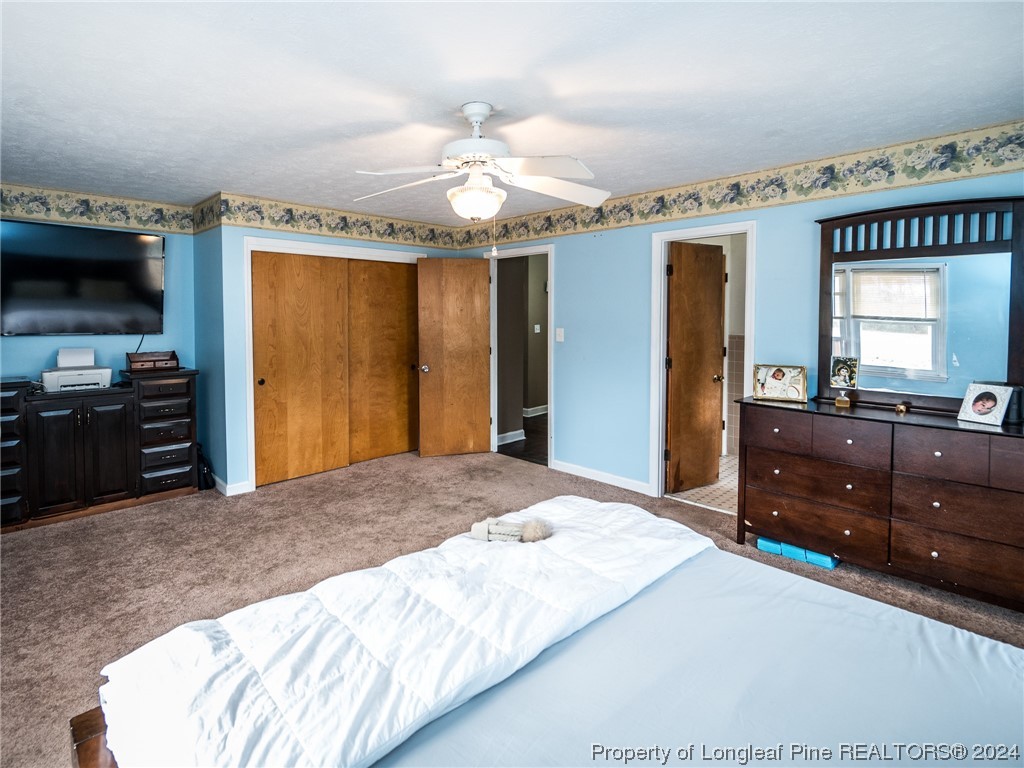 1982 Rowan Road, Unit R Lumberton, NC 28358 - Photo 30 of 43 a bedroom with a bed and a flat screen tv