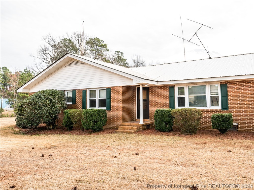 1982 Rowan Road, Unit R Lumberton, NC 28358 - Photo 3 of 43 a front view of a house with a yard