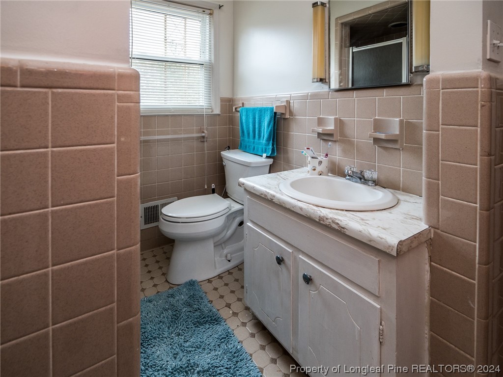 1982 Rowan Road, Unit R Lumberton, NC 28358 - Photo 33 of 43 a bathroom with a sink toilet and mirror