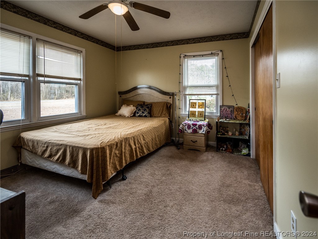 1982 Rowan Road, Unit R Lumberton, NC 28358 - Photo 35 of 43 a bedroom with a bed and a chandelier