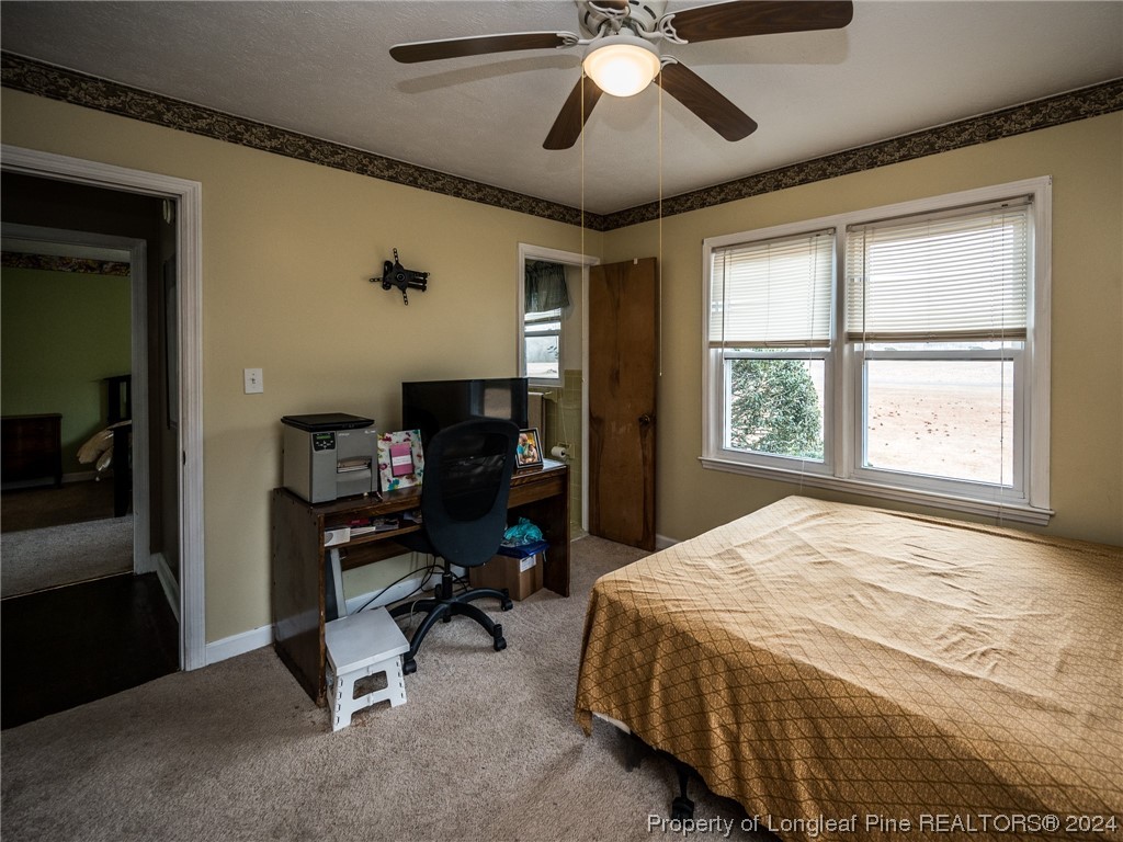 1982 Rowan Road, Unit R Lumberton, NC 28358 - Photo 36 of 43 a bedroom with a bed and a chandelier