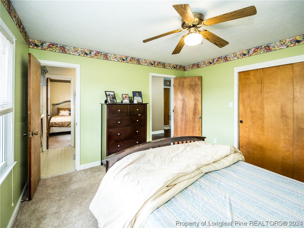 1982 Rowan Road, Unit R Lumberton, NC 28358 - Photo 40 of 43 a bedroom with a bed and a chandelier