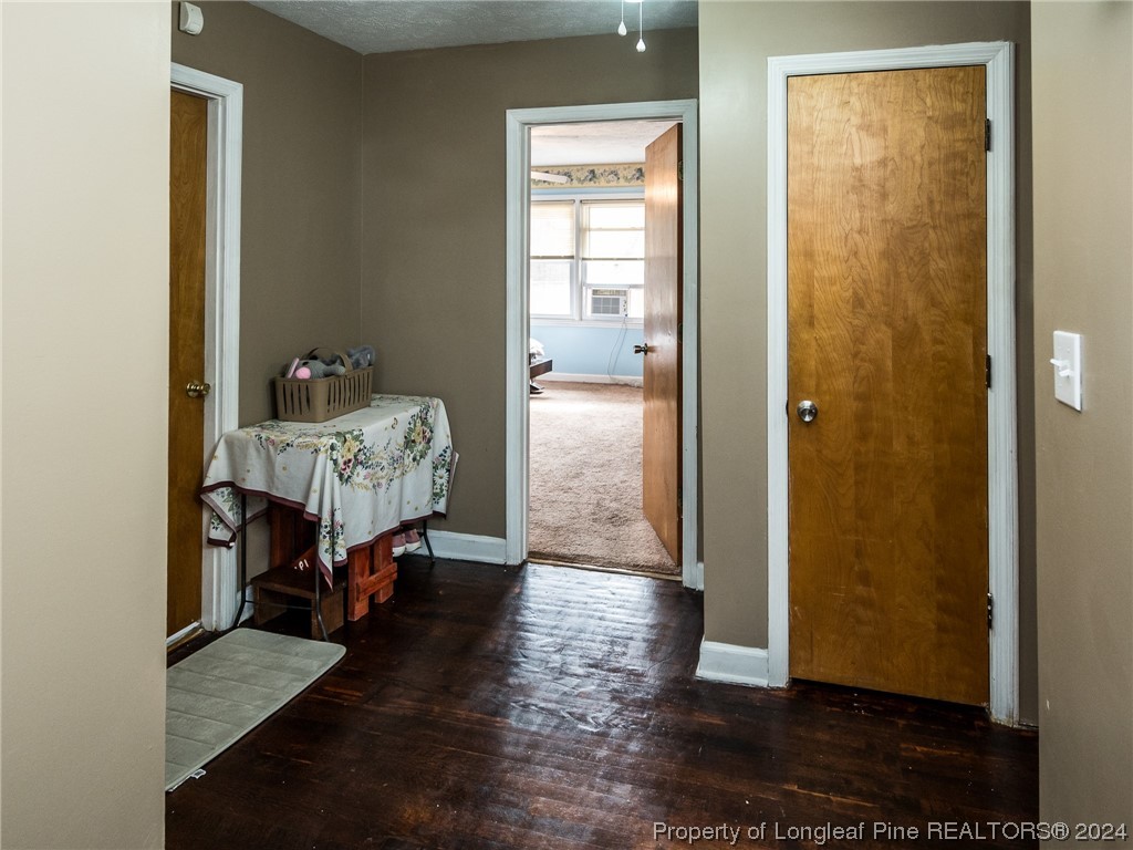 1982 Rowan Road, Unit R Lumberton, NC 28358 - Photo 41 of 43 a hallway with a wooden floor