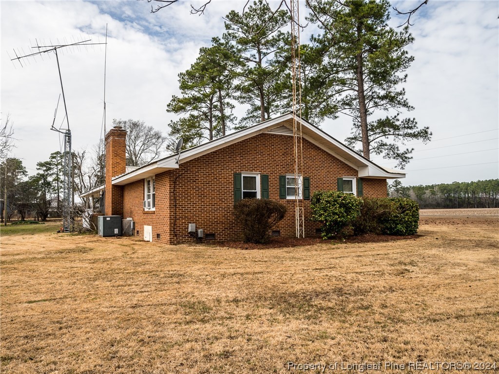 1982 Rowan Road, Unit R Lumberton, NC 28358 - Photo 9 of 43 a house that has a tree in front of it