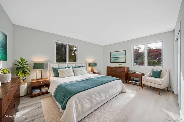 a spacious bedroom with a bed and a couch