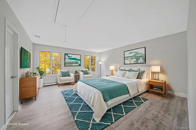 a bedroom with a large bed and a couch