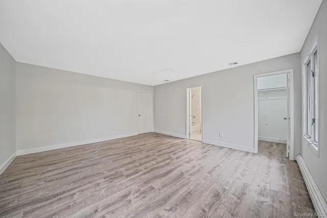 a view of an empty room and wooden floor