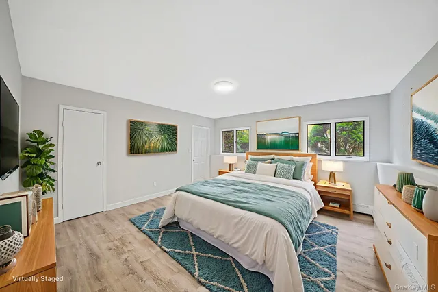 a bedroom with a bed and a potted plant