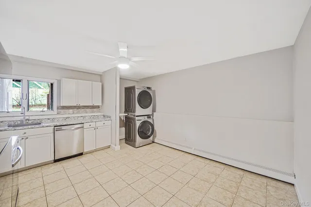 a bathroom with a sink a washer and dryer