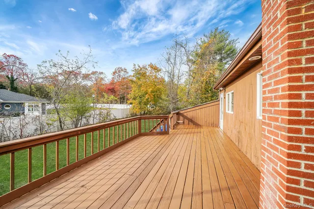 a view of balcony with wooden floor and fence