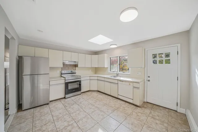 a kitchen with a refrigerator and a sink