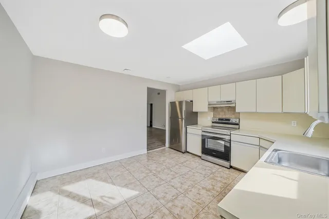 a kitchen with a sink stove and refrigerator