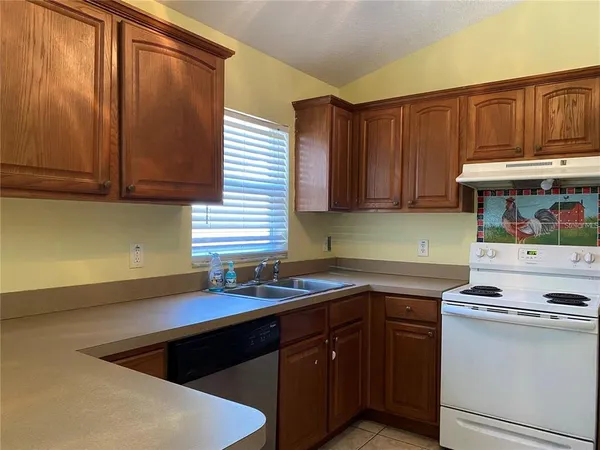 a kitchen with stainless steel appliances granite countertop a sink stove and cabinets