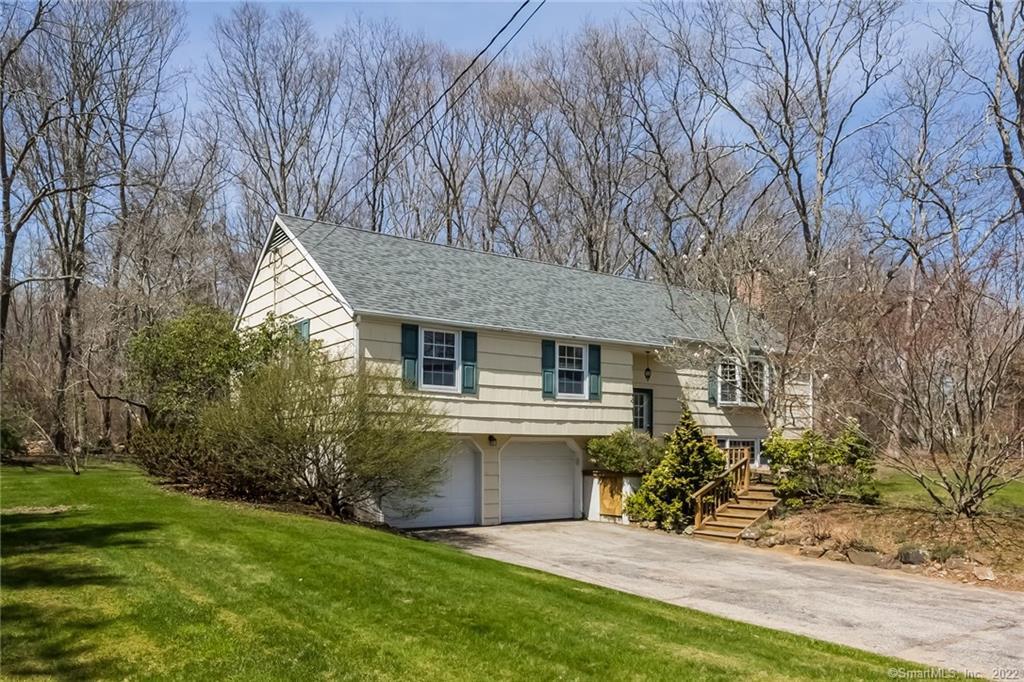 23 Riverside Terrace Madison, CT 06443 - Photo 1 of 1 a backyard of a house with plants and large tree