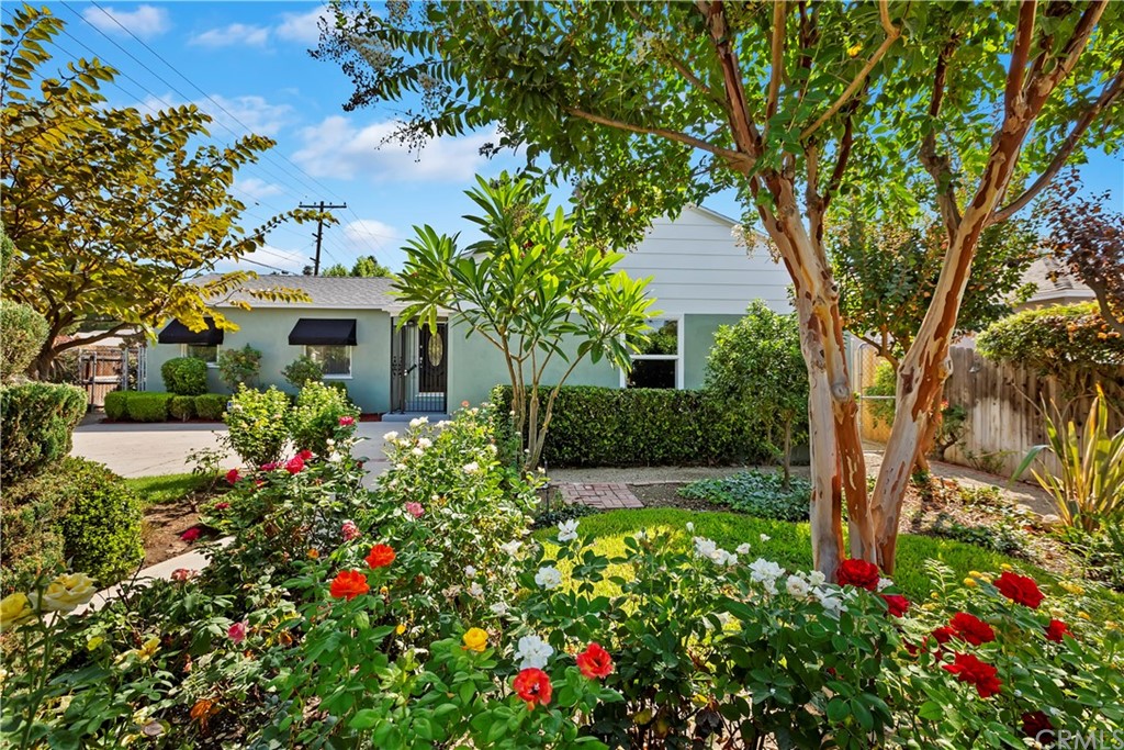 6006 Hamilton Drive Riverside, CA 92506 - Photo 1 of 1 a front view of a house with a yard and fountain in middle