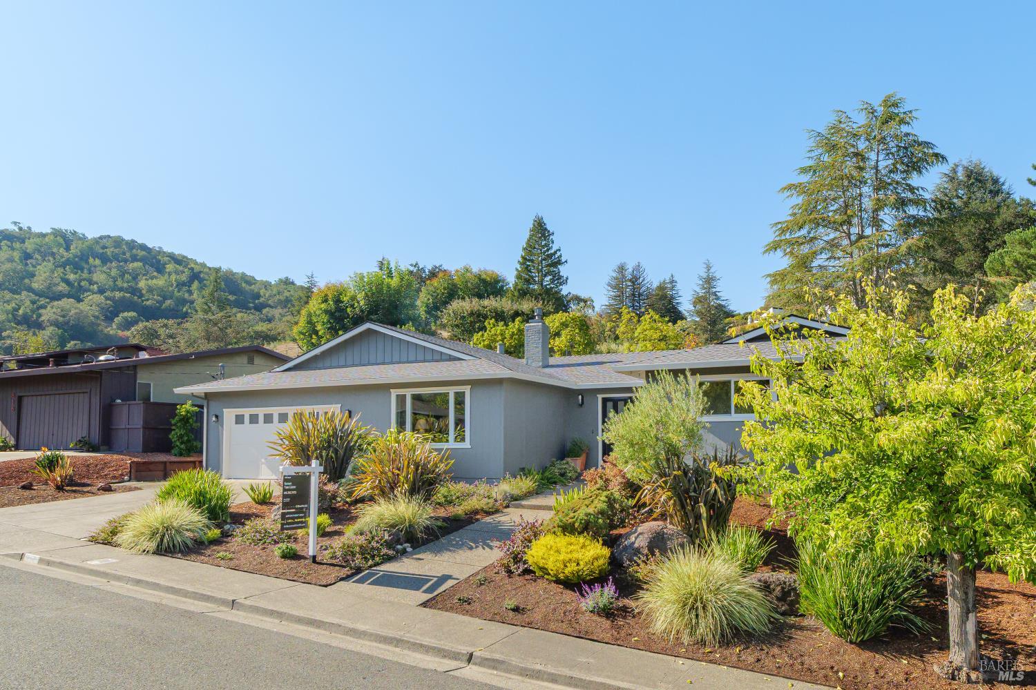 a front view of a house with a yard and outdoor seating