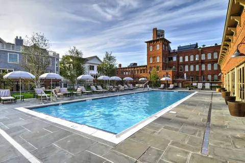 a living room with fireplace furniture and a large window