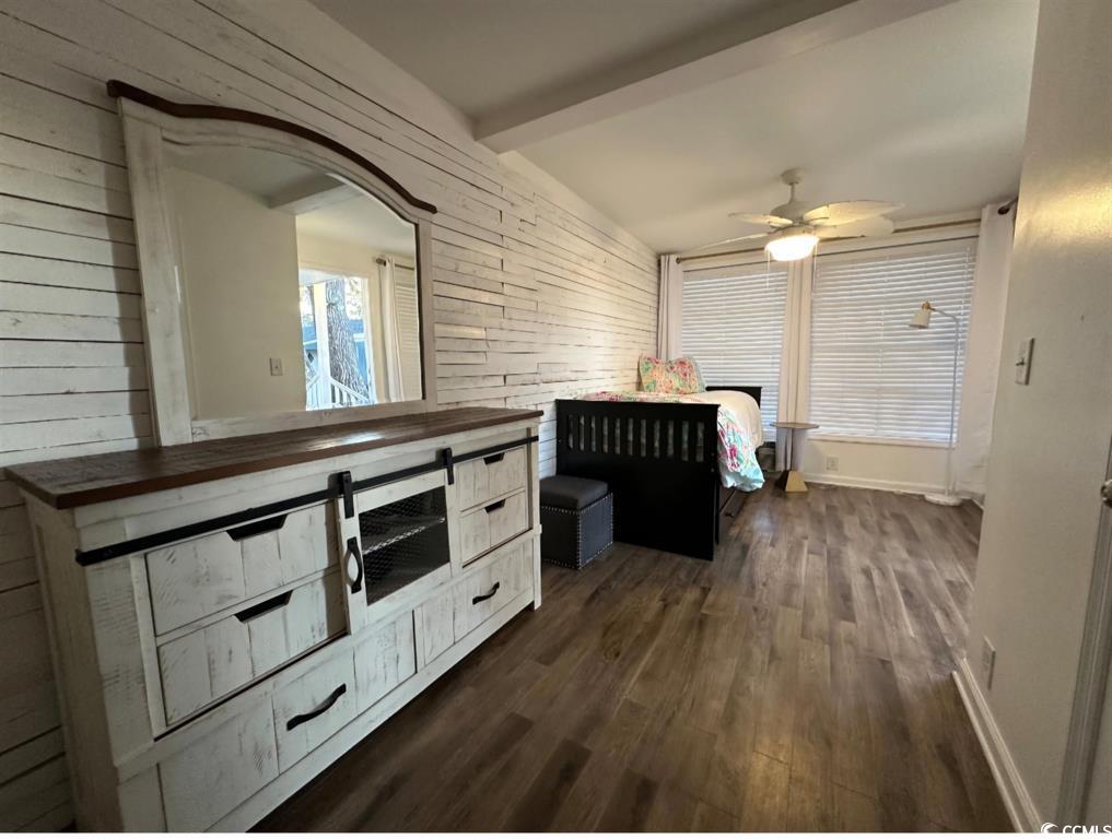 315 Inlet Road Murrells Inlet, SC 29576 - Photo 16 of 19 Unfurnished bedroom featuring wooden walls, dark wood-type flooring, beam ceiling, and ceiling fan