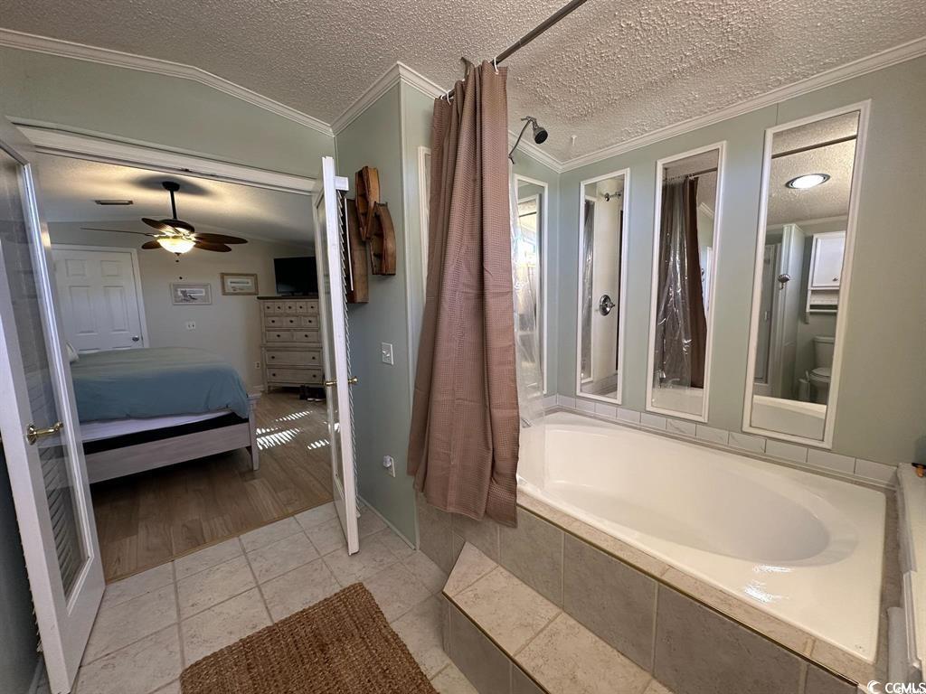 315 Inlet Road Murrells Inlet, SC 29576 - Photo 17 of 19 Ensuite bathroom featuring a textured ceiling, light tile patterned floors, crown molding, and a ceiling fan
