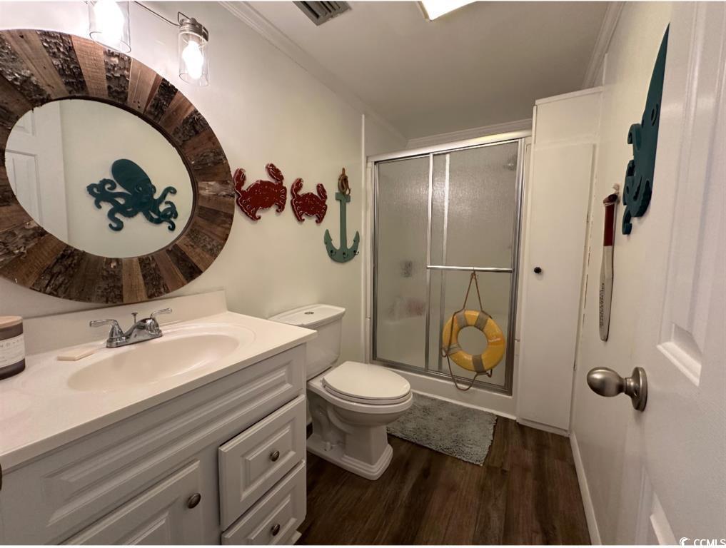 315 Inlet Road Murrells Inlet, SC 29576 - Photo 18 of 19 Bathroom with a shower stall, vanity, dark wood-style flooring, and crown molding
