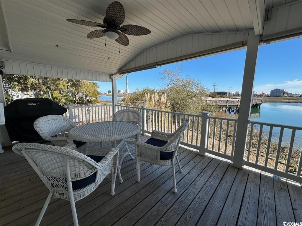 315 Inlet Road Murrells Inlet, SC 29576 - Photo 2 of 19 Wooden terrace featuring a water view, outdoor dining space, and a ceiling fan