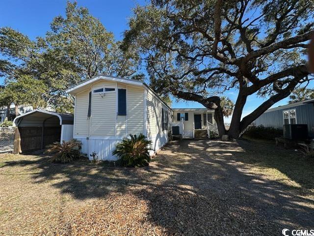 315 Inlet Road Murrells Inlet, SC 29576 - Photo 6 of 19 View of property exterior featuring a carport and a central air condition unit