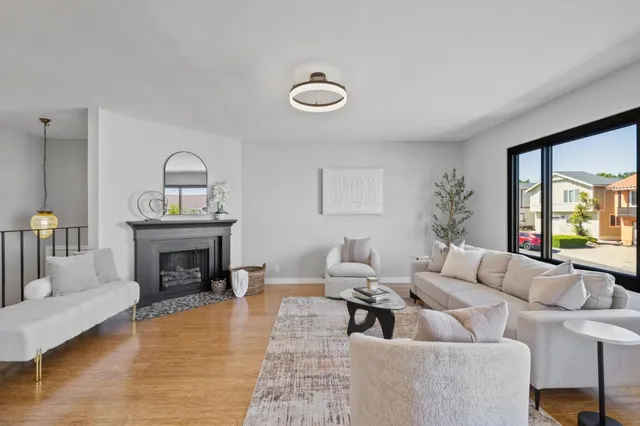 a living room with furniture and a chandelier