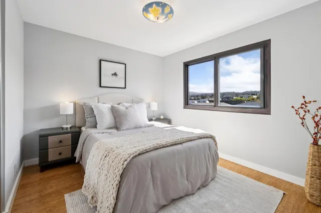 a bedroom with a bed and a window