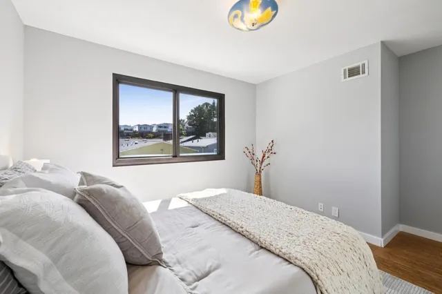 a view of a backyard with couches plants and wooden fence