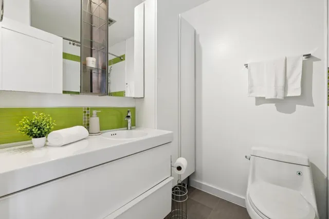 a front view of a house with a garden and patio