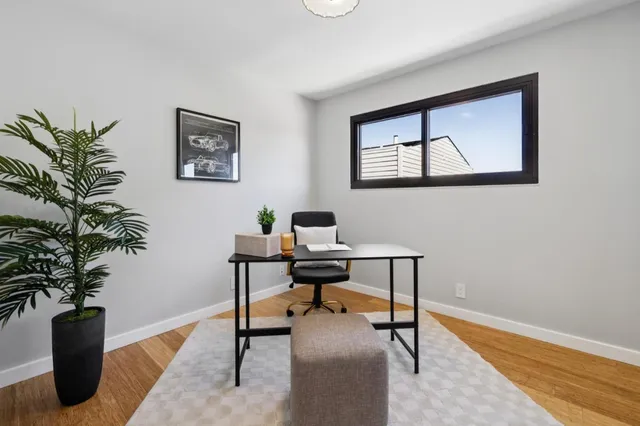 a view of a city street with a cars park side of a road