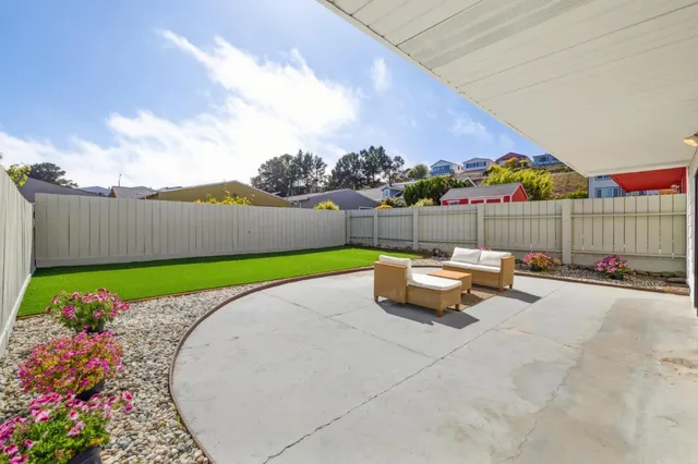 a front view of a building with sitting area