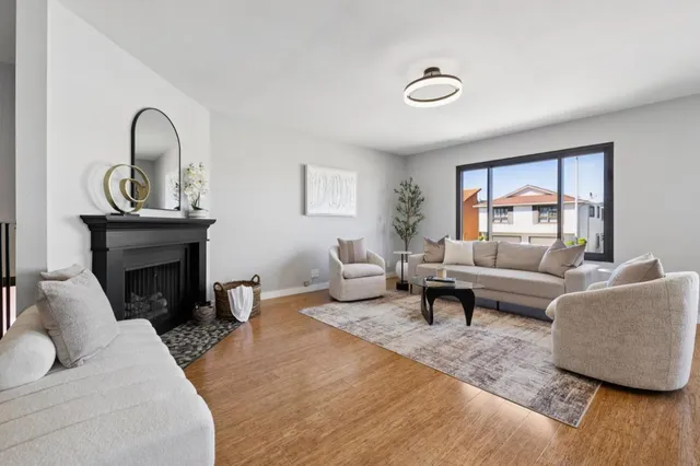 a living room with furniture and a chandelier