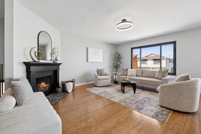 a living room with furniture and a floor to ceiling window