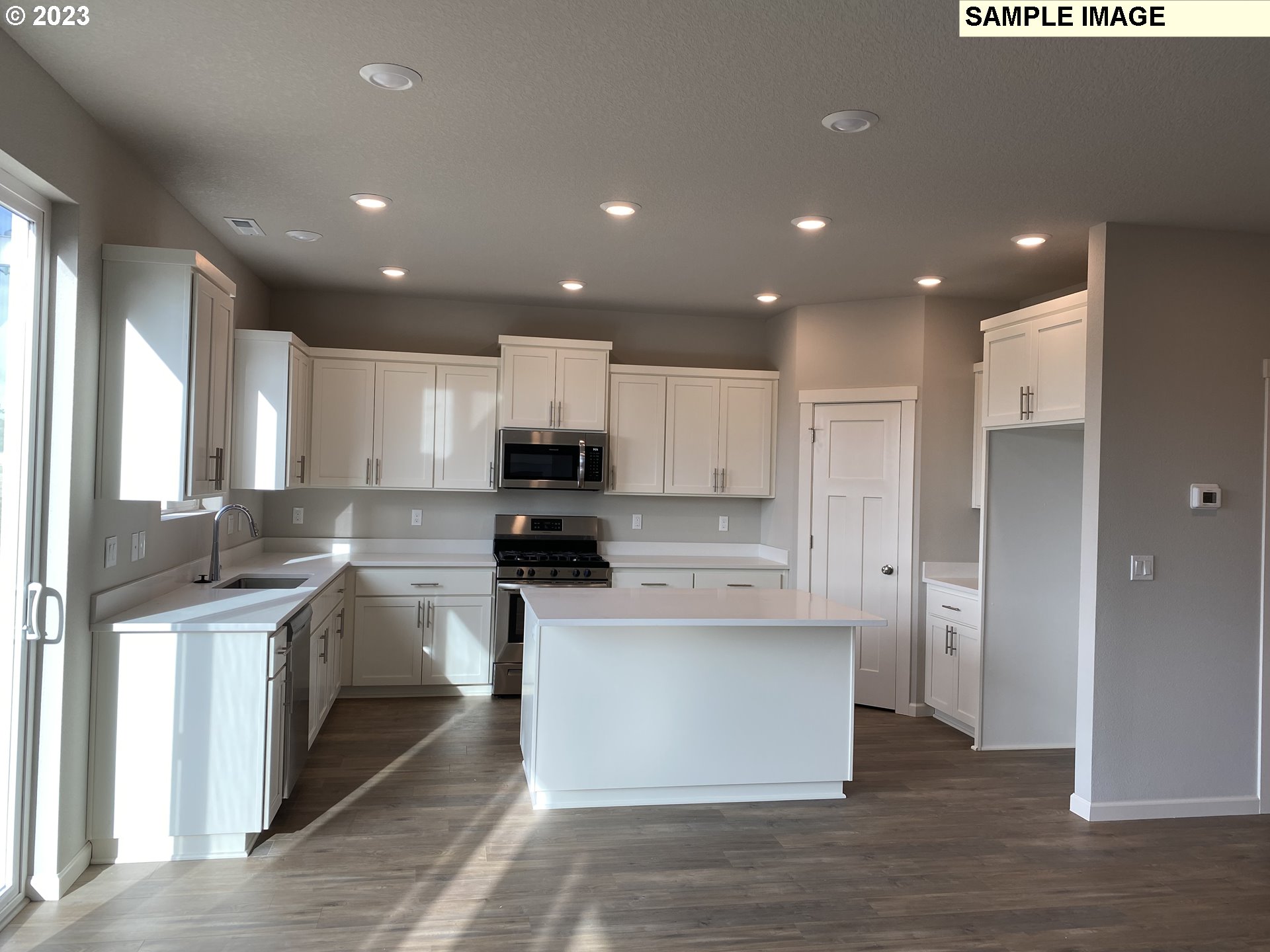 1020 Marie Street Mount Angel, OR 97362 - Photo 3 of 15 a large kitchen with stainless steel appliances granite countertop a stove a sink and a refrigerator