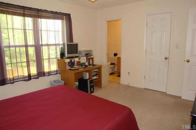 2220 Violet Court Raleigh, NC 27604 - Photo 7 of 10 a bedroom with a bed and a large window