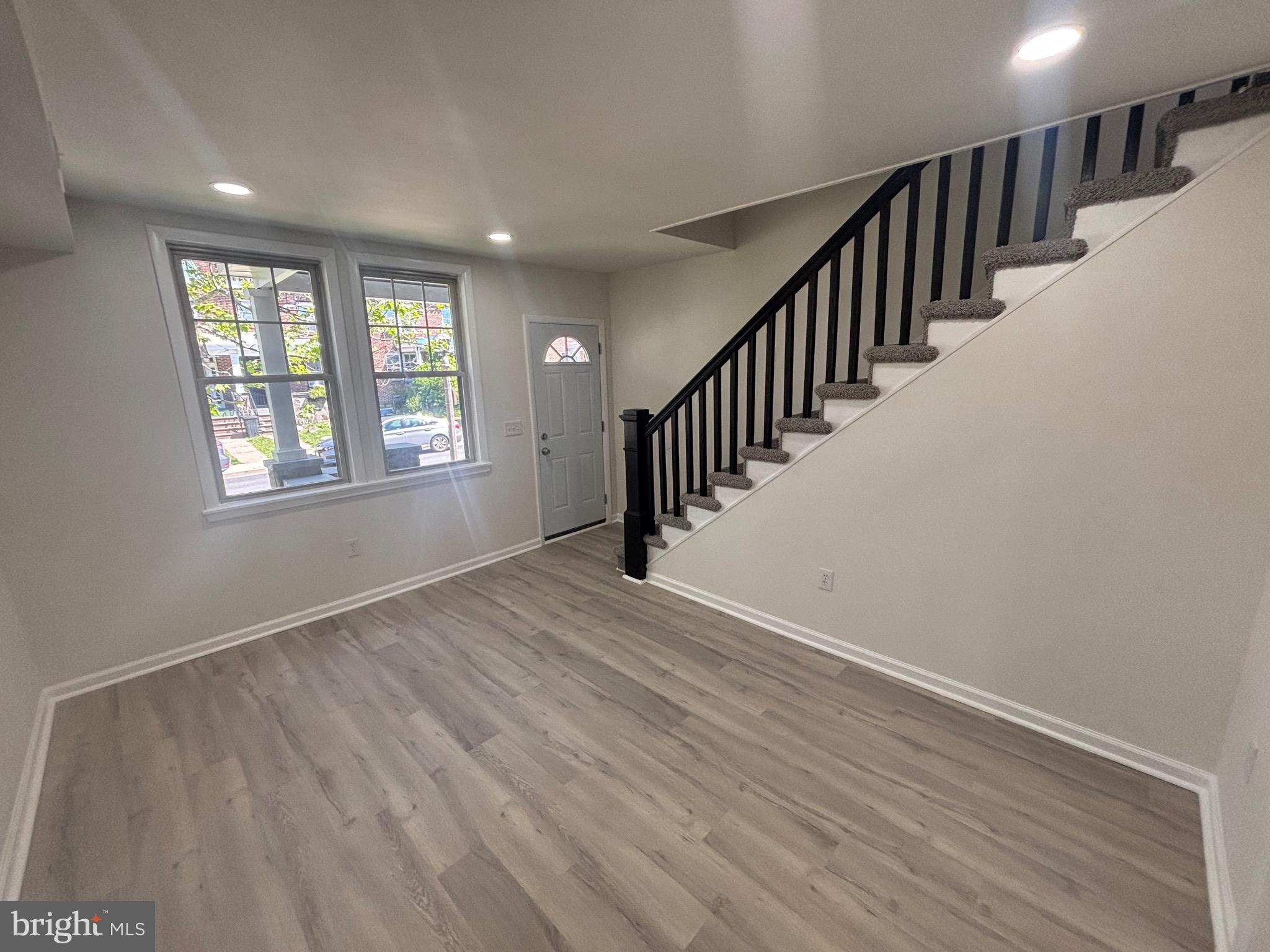 6769 Woodley Road Baltimore, MD 21222 - Photo 12 of 27 wooden floor in an empty room with a window