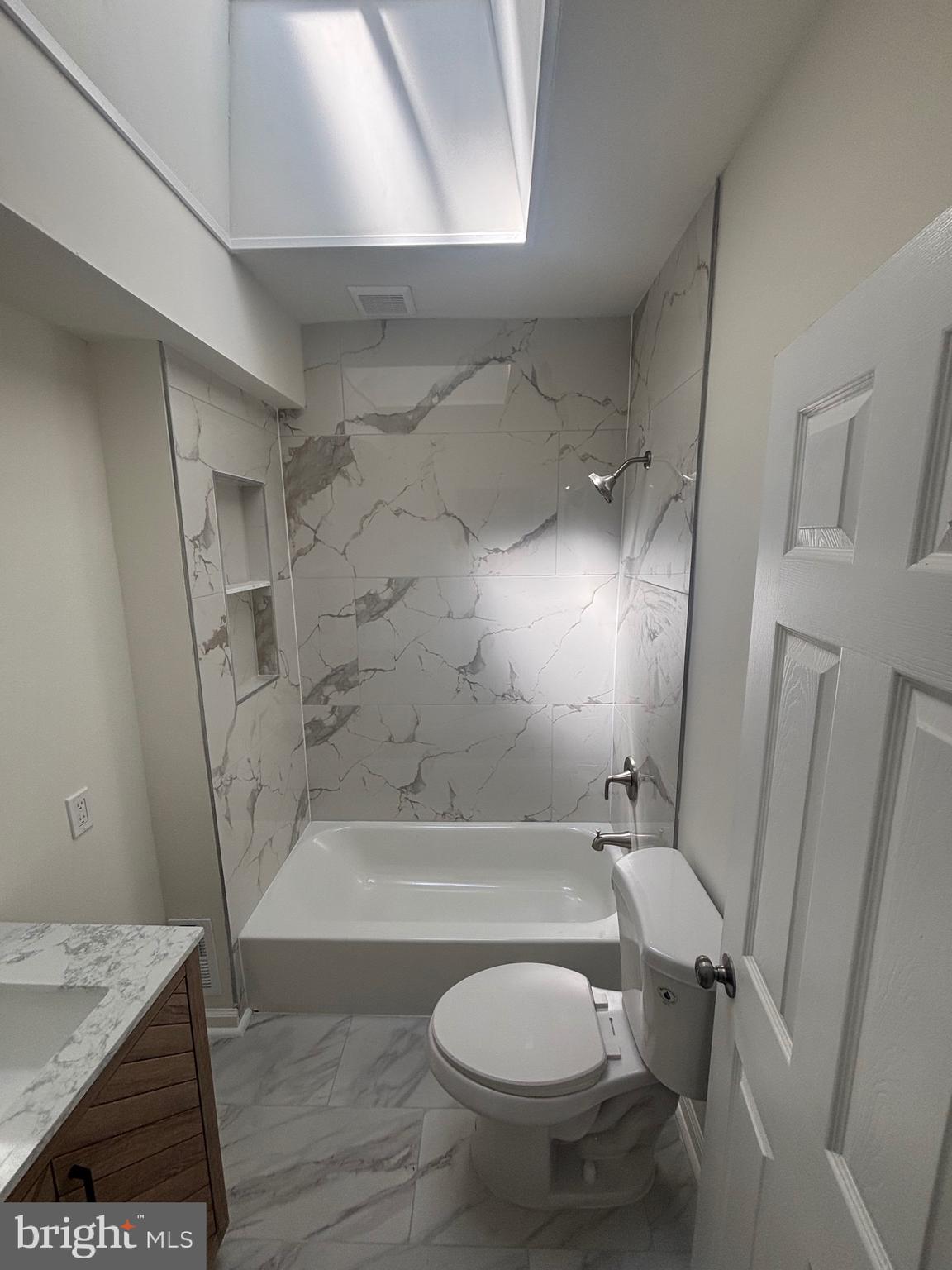 6769 Woodley Road Baltimore, MD 21222 - Photo 14 of 27 a bathroom with a sink a toilet and shower