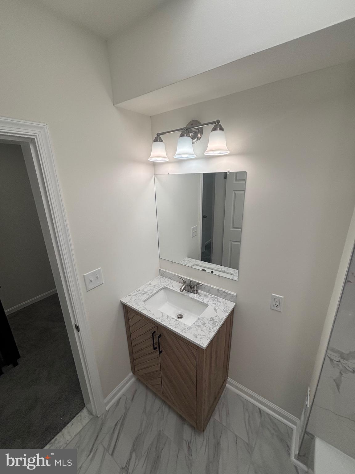 6769 Woodley Road Baltimore, MD 21222 - Photo 15 of 27 a room with a sink and a mirror