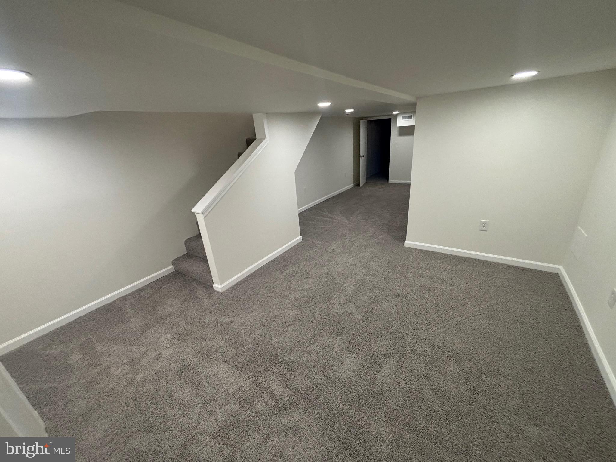 6769 Woodley Road Baltimore, MD 21222 - Photo 20 of 27 a view of an empty room with stairs
