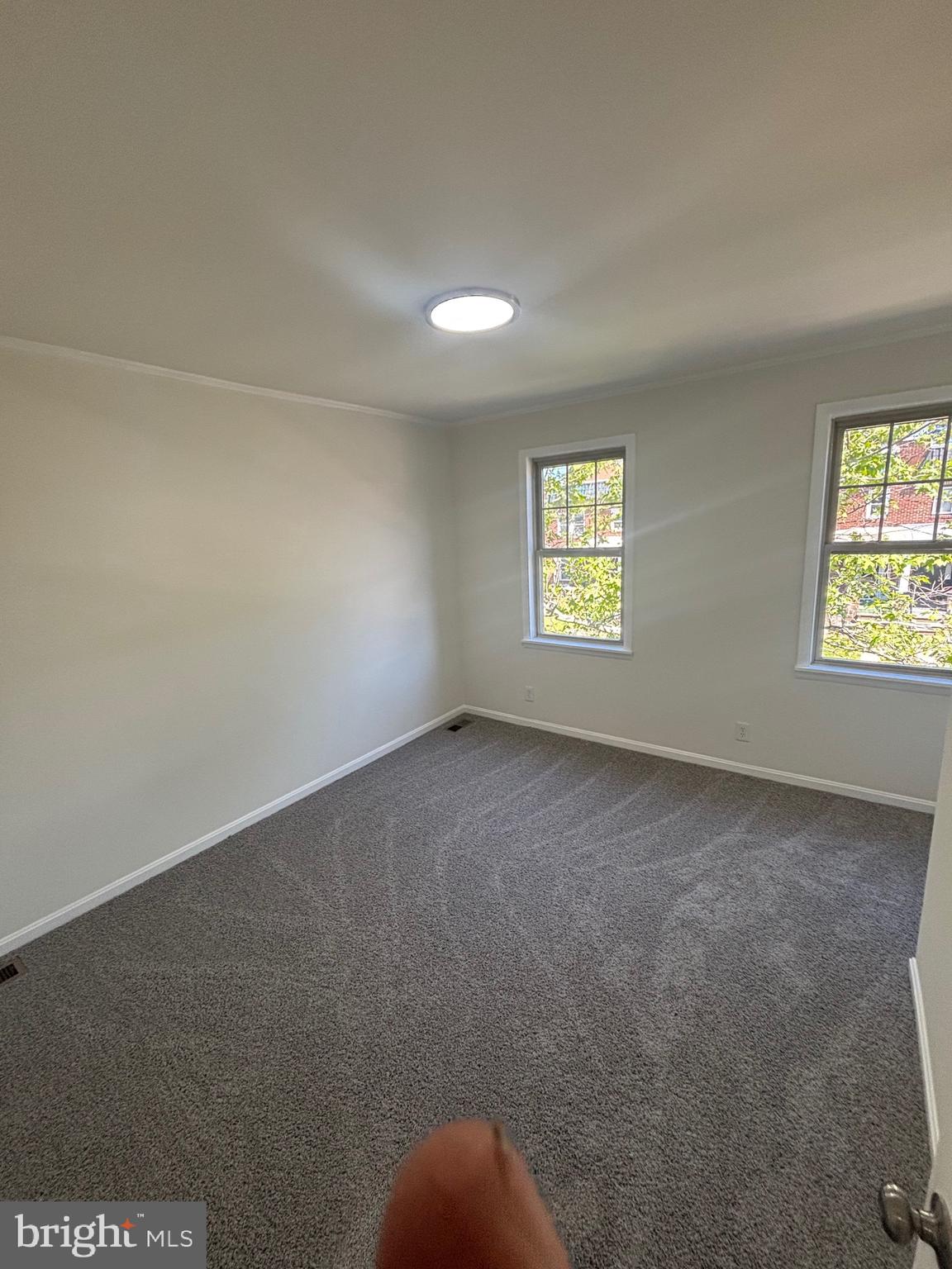 6769 Woodley Road Baltimore, MD 21222 - Photo 22 of 27 an empty room with windows